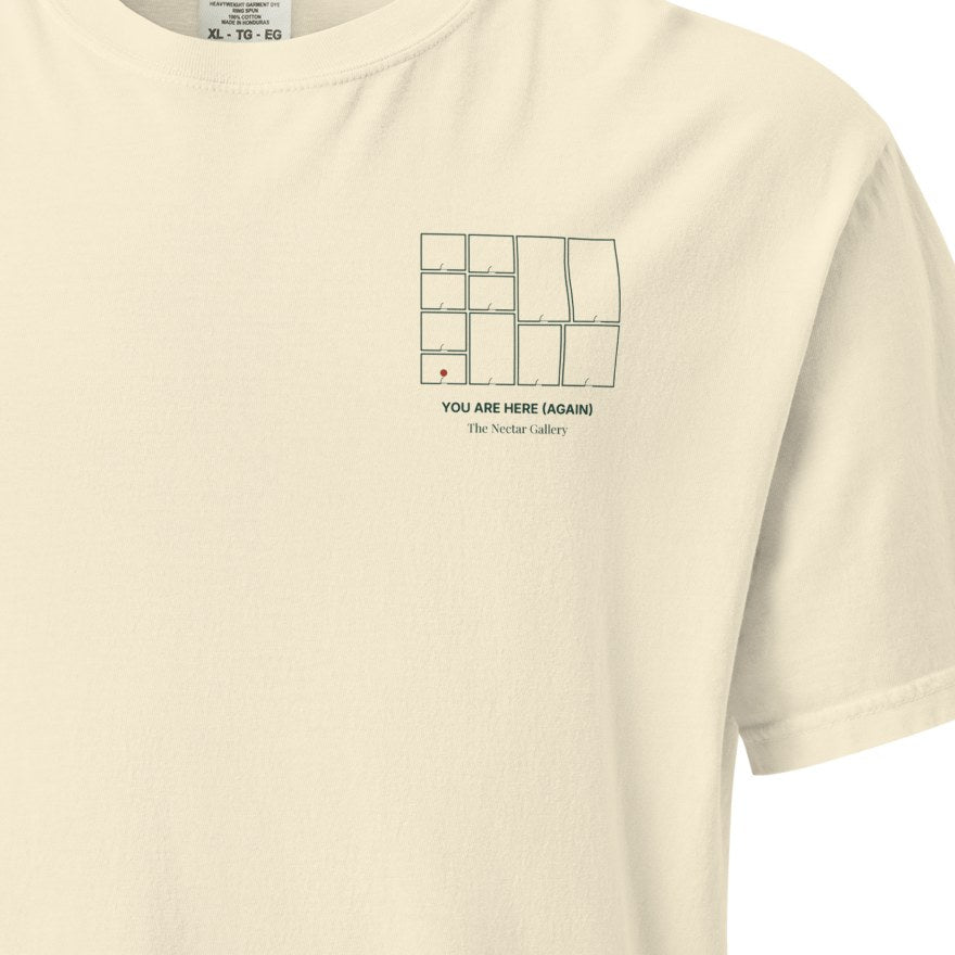 Close-up of the small floorplan print on the left chest of the ivory tee